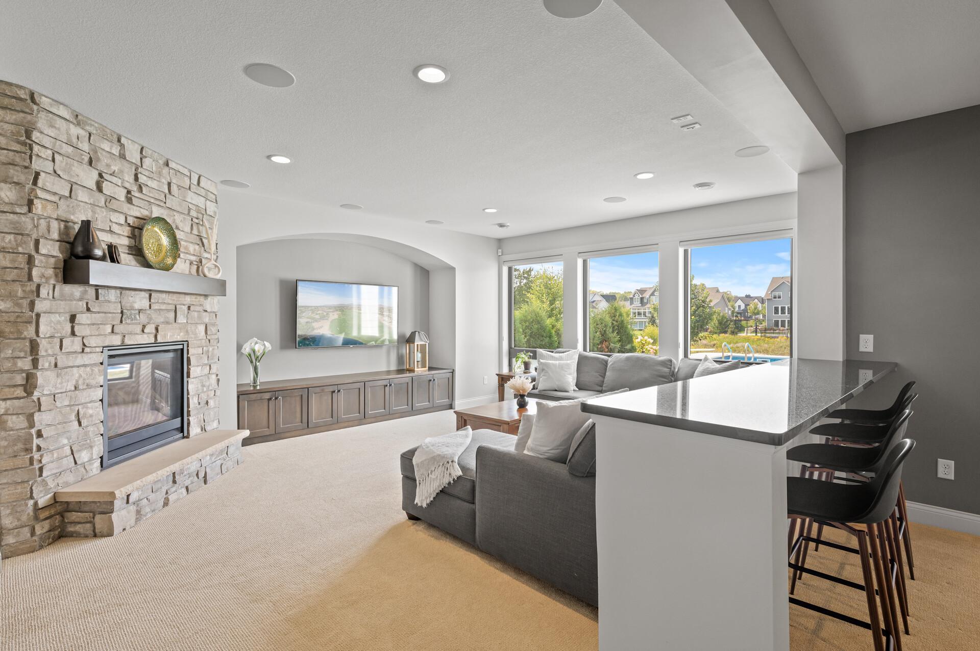 Inviting family room in the lower level, centered around yet another gas fireplace, creating a cozy atmosphere.