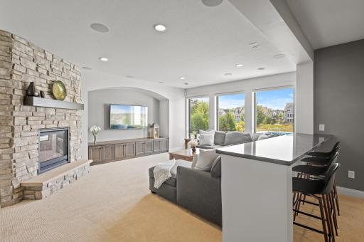Inviting family room in the lower level, centered around yet another gas fireplace, creating a cozy atmosphere.