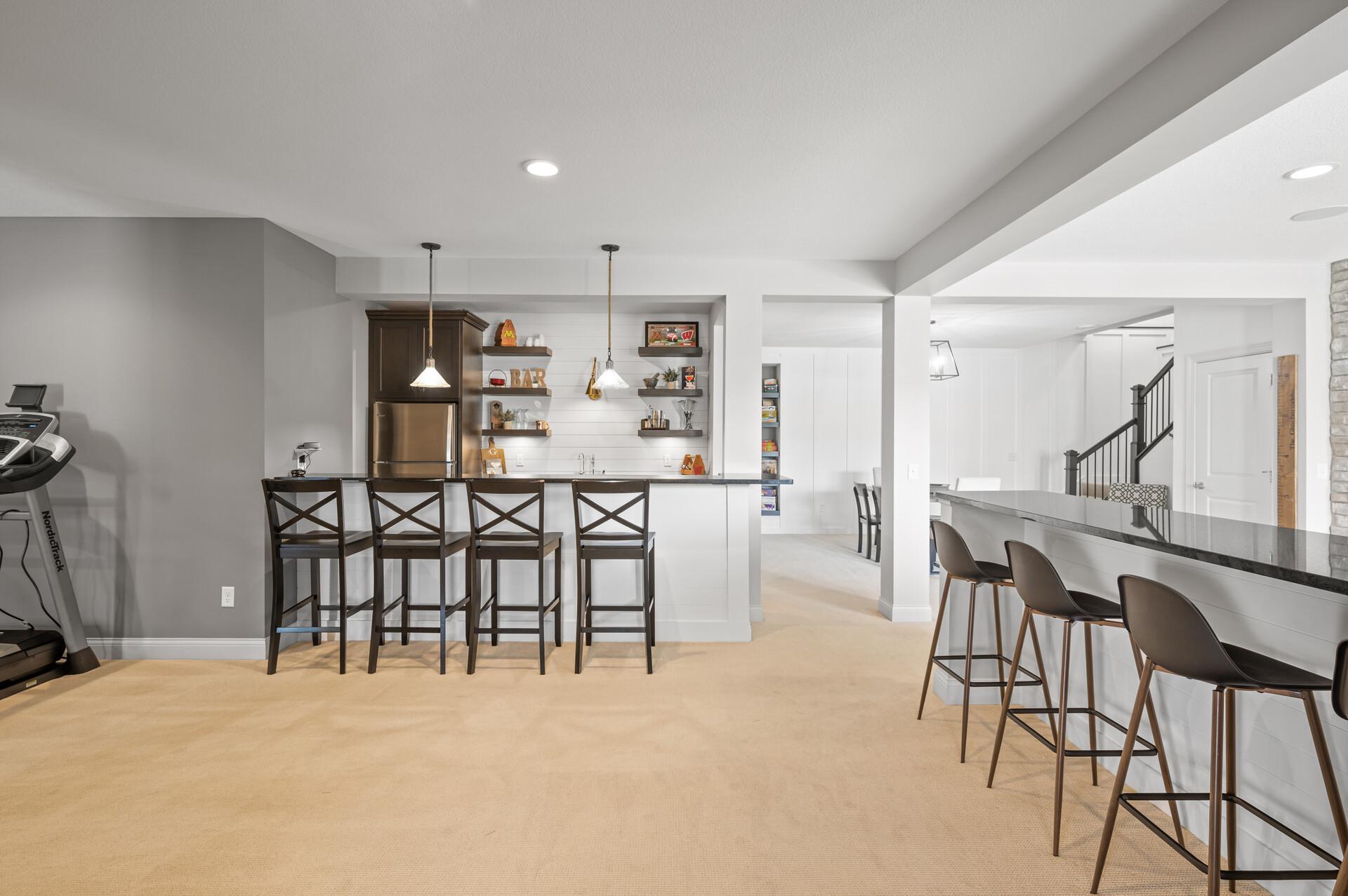 Stylish wet bar with bar seating, providing an ideal setup for entertaining and hosting gatherings.