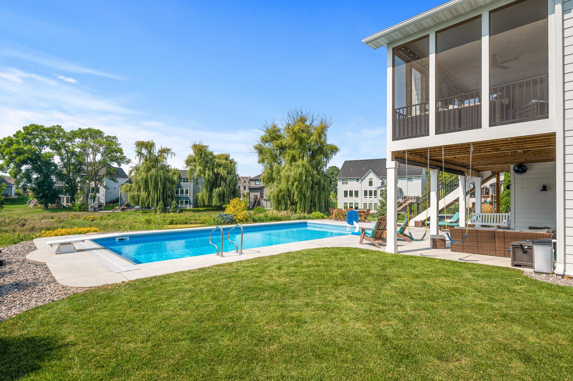 Stunning backyard with an in-ground pool, creating a private oasis for relaxation and entertainment. Picturesque views of the surroundings add to the tranquility of the setting.