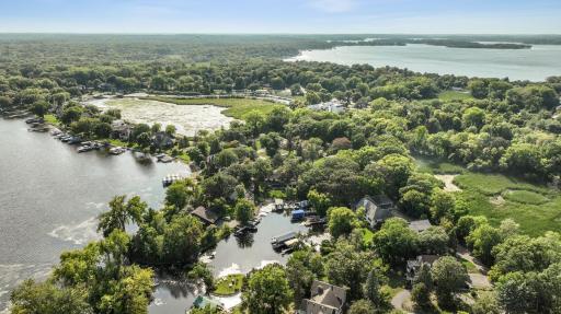 Located in the serene Gideon Bay enclave on Lake Minnetonka, this captivating two-story home offers an idyllic waterfront experience. Boasts an impressive 70-ft of lakeshore complete with a 49-ft permanent dock and 24-ft boat house, plus a boat lift!