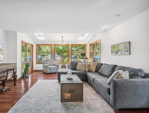 Inside, the home seamlessly combines elegance and comfort, with a stunning family room graced by dual skylights that frame magnificent harbor views and direct access to a spacious deck.