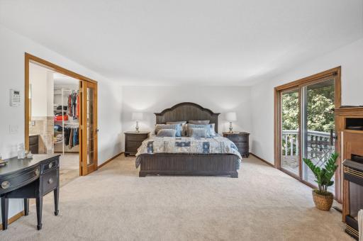 Enormous Primary Suite positioned on the upper level, with its own private three-quarter bathroom with beautiful finishes, walk-in closet and private balcony with a lake view!