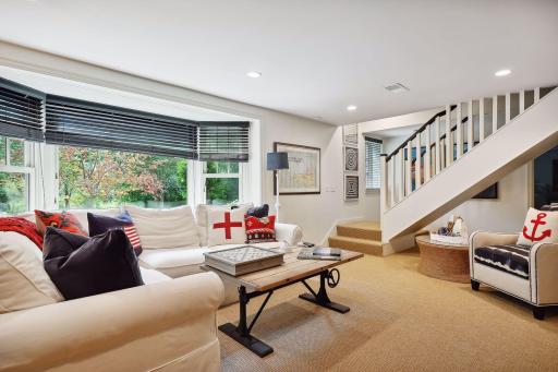 Lower level living room with large windows.