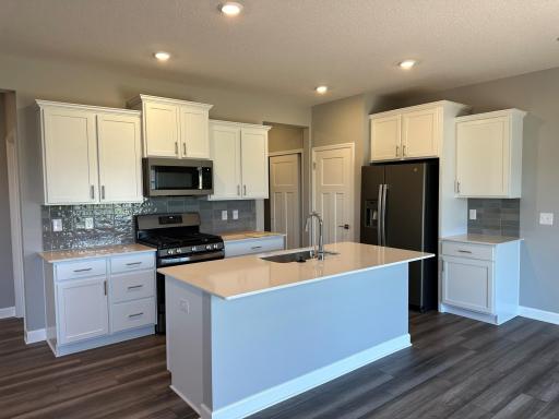 Designer level kitchen with rich walnut color backsplash. What's not to love!