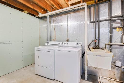 The laundry room and utility room are both located on the lowest level along with tons of extra storage space. A new water softener (2017) and high efficiency furnace (2016) have been installed.