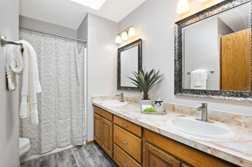 The upper level full bathroom is equipped with new faucets and a recently replaced skylight!