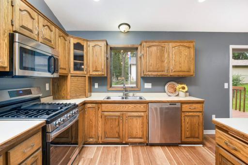 The kitchen offers a charming above sink window, stainless steel appliances, and tons of cabinet space!