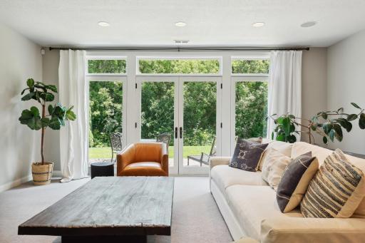 Photo for 16655 32nd Avenue N, Plymouth, MN 55447 - Listing #6430181 Lower-level family room offers a wall of windows and doors going out to the backyard. This was intentional for a future pool, and you enjoy the incredible amount of light this affords the space.