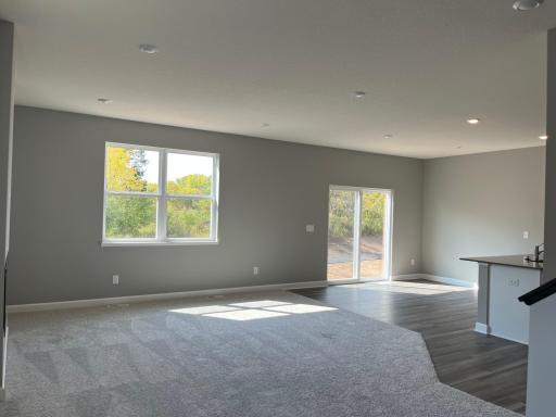 The main level is amplified by the warm natural light from the large windows.