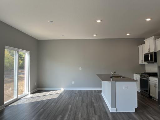 Soaked in natural sunlight, the homes eat-in dining room has ample space for a dining table located in the heart of the home.