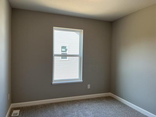 The first of two spacious secondary bedrooms.