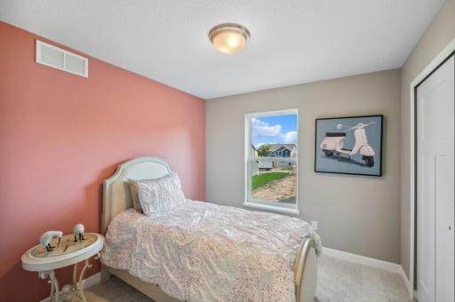Another view of one of the spacious secondary bedrooms! (Photo of decorated model, actual home's finishes may vary slightly)