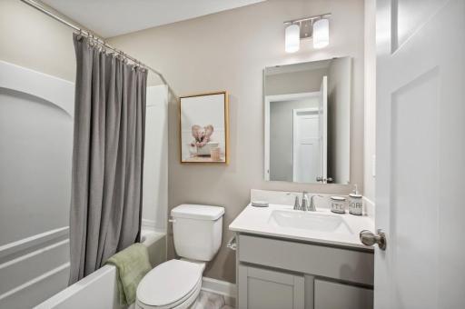 The home's secondary bat provides plenty of space for everyone to get ready during those busy mornings. (Photo of decorated model, actual home's finishes may vary slightly)