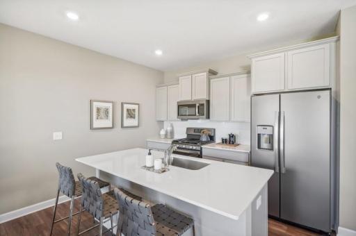 Imagine preparing a wonderful meal for dinner in this kitchen or entertaining friends and family over the weekend! (Photo of decorated model, actual home's finishes may vary slightly)