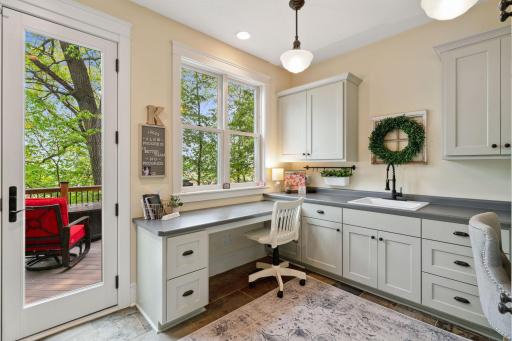 Resource room with desk area, soaking sink and washer and dryer.