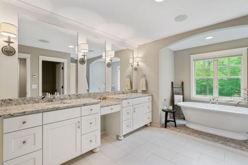 Owners suite private bathroom with separate soaking tub and walk-in shower.