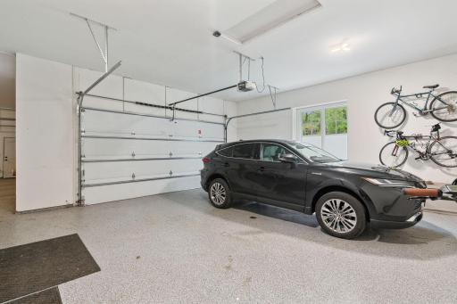 Attached 4 1/2 car garage with expoxy floor, floor drain and heated.