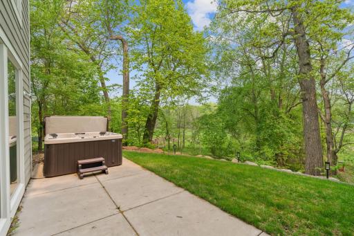 Hot tub space on the lower level patio at the back of the home.