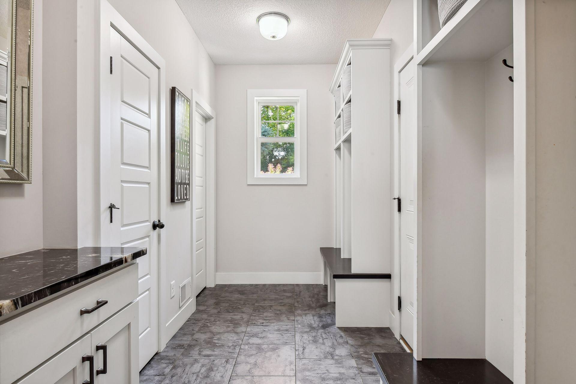 Designed to help keep you organized - the Mud Room features tiled flooring, four built-in lockers, a walk-in closet with a custom organizer system and convenient drop-station.