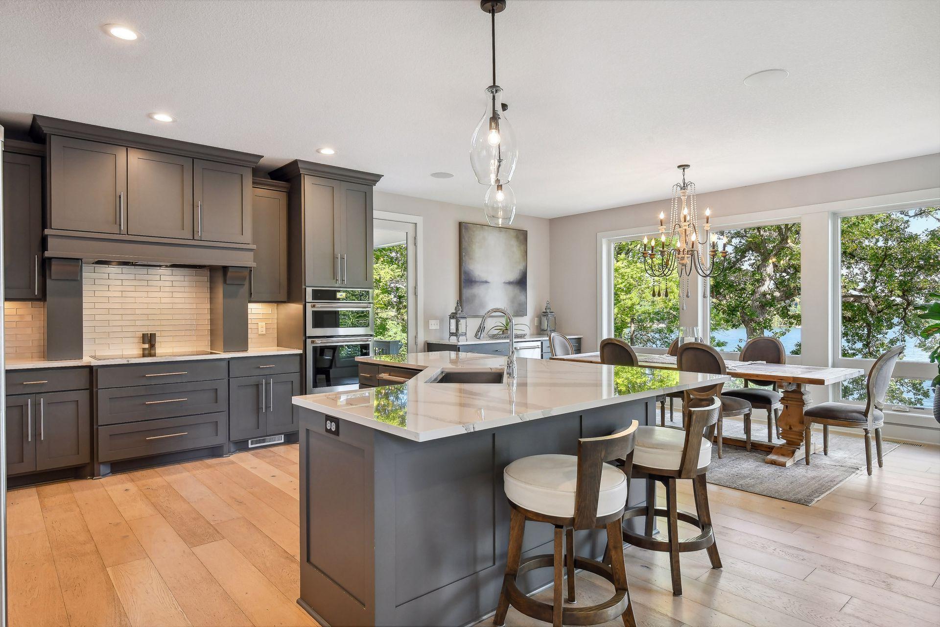 The well-equipped Kitchen features custom cabinetry with soft-close drawers and gleaming quartz countertops.