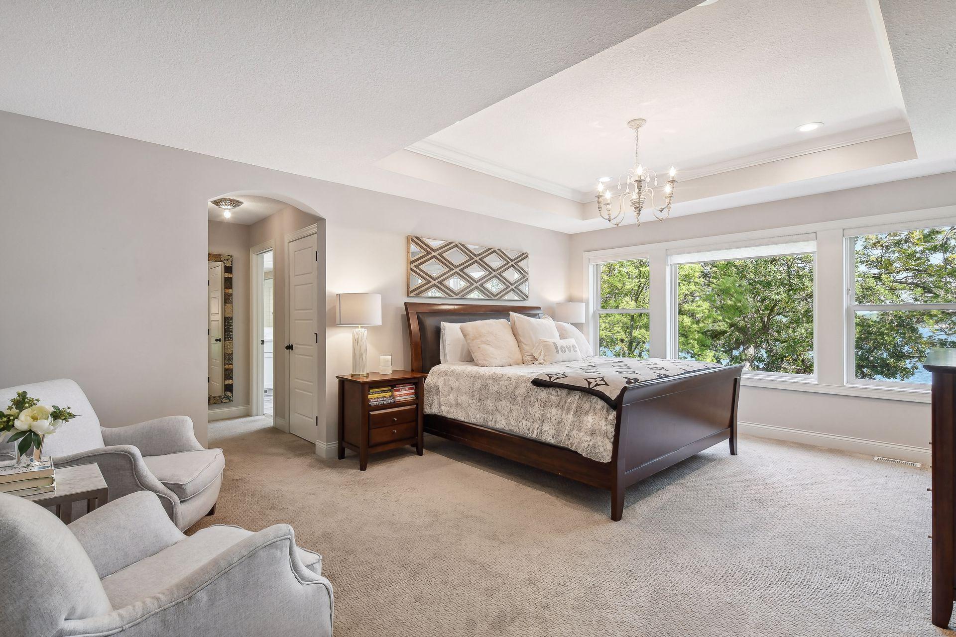 The Primary Suite is a private oasis with a box vaulted ceiling and spacious walk-in closet complete with a custom California Closet organizer system.