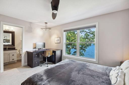 In addition to the primary suite, the upper level houses two additional Junior Suites - this bedroom features a built-in corner desk and walk-in closet with a custom California Closet organizer system.