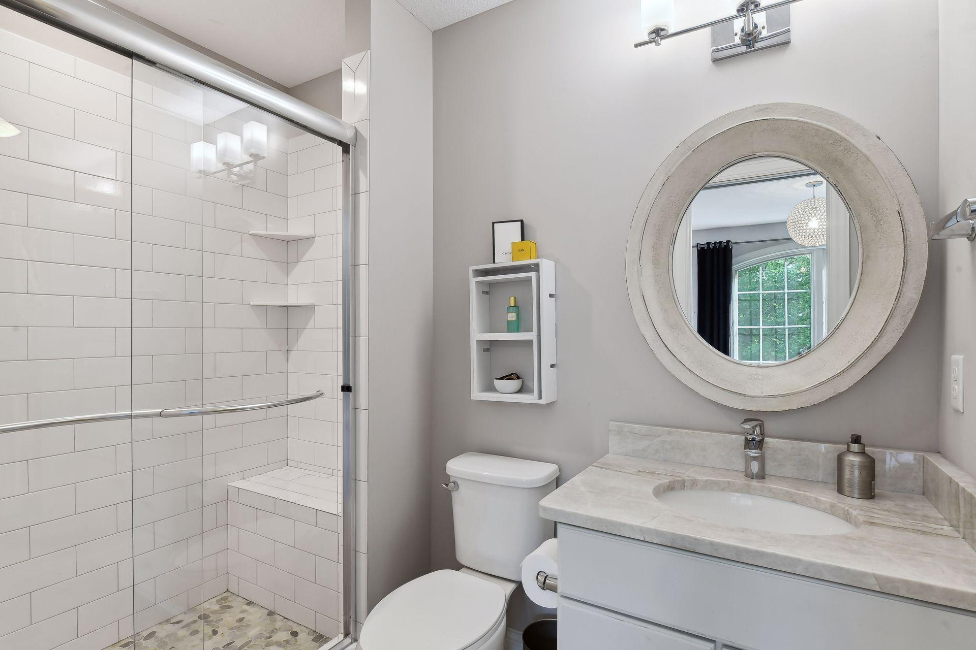 The private 3/4 en suite bathroom offers a subway tiled shower and quartz countertop.