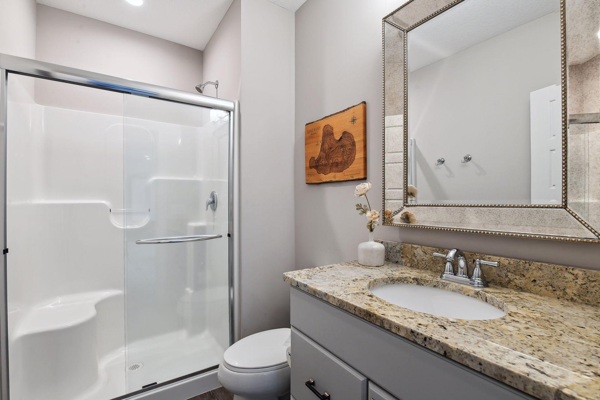 A 3/4 Bathroom with LVT flooring and granite countertops completes the lower level.