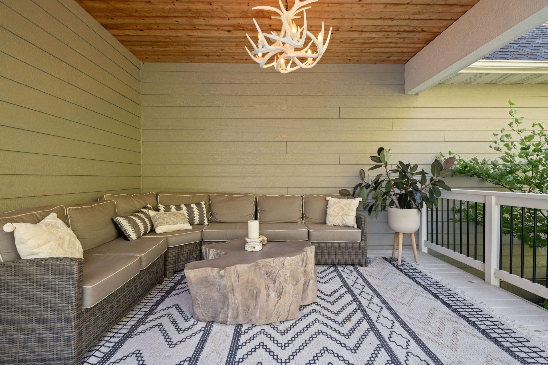 Just off the Kitchen is the covered Deck that offers a tongue and groove cedar ceiling with built-in speakers and beautiful light fixture.