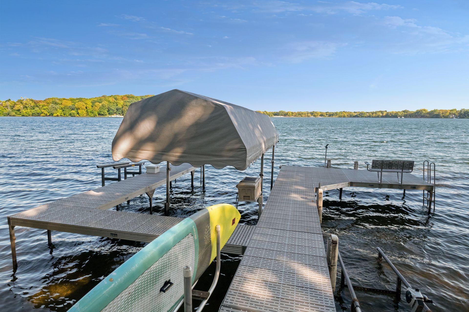 With over 150-feet of sandy shoreline, this home offers resort-style living with a close-in location.