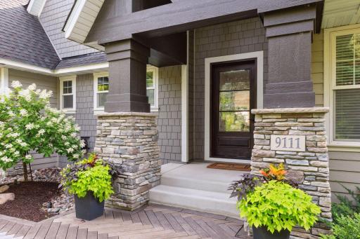 A custom paver walkway leads to the inviting front door.