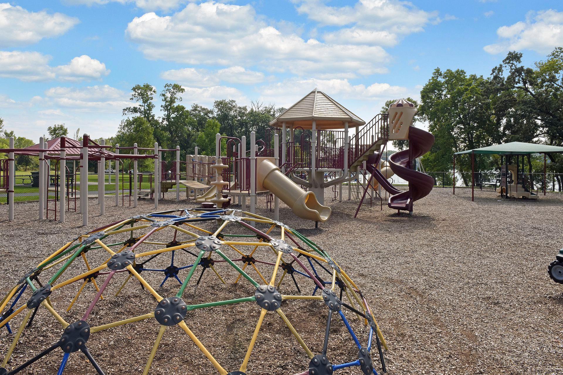The park features play structures, a picnic shelter and sport courts.