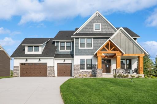 Nice long concrete driveway, black Andersen windows, 4 sided architecture and stained accents!