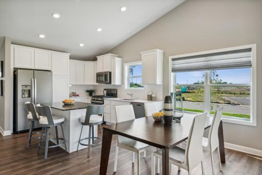 A spacious dining area is located next to the kitchen. *Photos are of a model home; actual features and colors will vary.