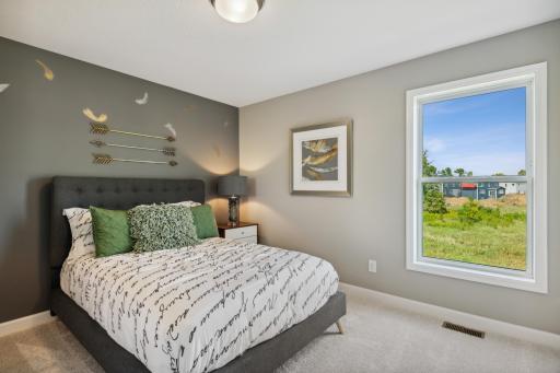 One of three upper level bedrooms. *Photos are of a model home; actual features and colors will vary.
