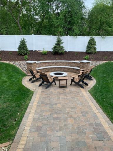 Enjoy all the seasons in your private backyard with custom built firepit, built in seating and paver patio