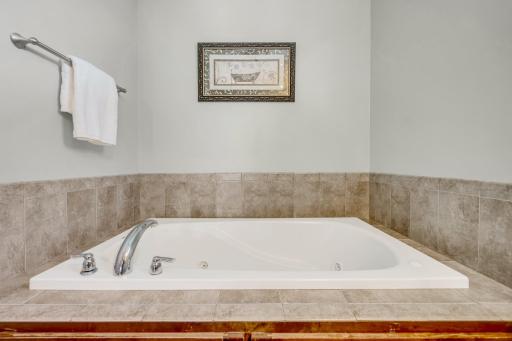 Jetted soaking tub, raised cabinets, double sinks, walk in ceramic shower