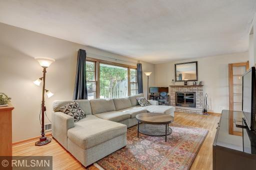 Huge living room capably hosts this large sectional! Note the woodburning fireplace!