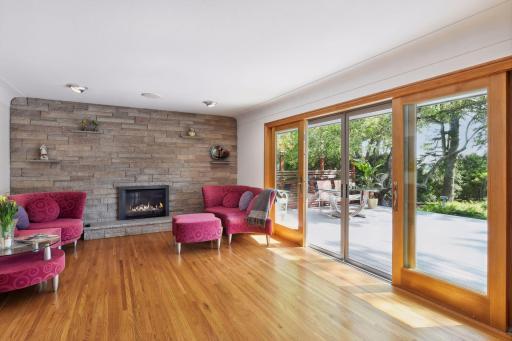 The living room's stone wall, gas-burning fireplace, and hardwood floors with radiant heating create an inviting ambiance. Perfect for cozy evenings!