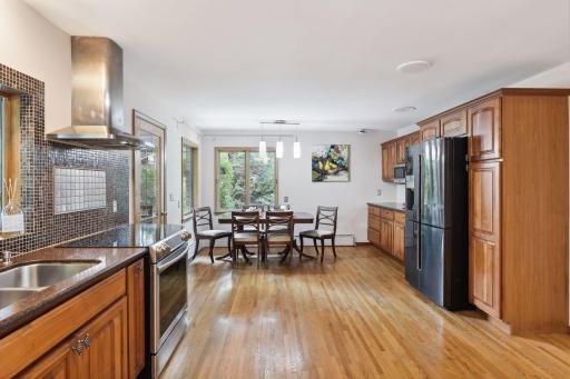 Natural light fills the kitchen's informal dining area, creating a warm and inviting space for family meals and gatherings.