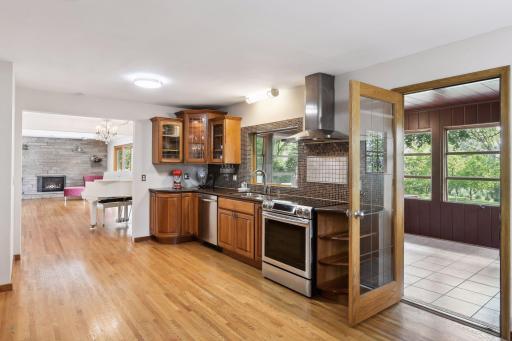 You can access the three-season porch from the kitchen and dining area, offering a perfect spot to relax and savor the outdoors in comfort.