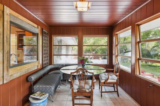 Embrace the outdoors year-round in this inviting porch, equipped with plumbing and prepped for radiators, easily transforming it into a cozy four-season haven. A perfect spot to relish nature's beauty in comfort, no matter the weather!