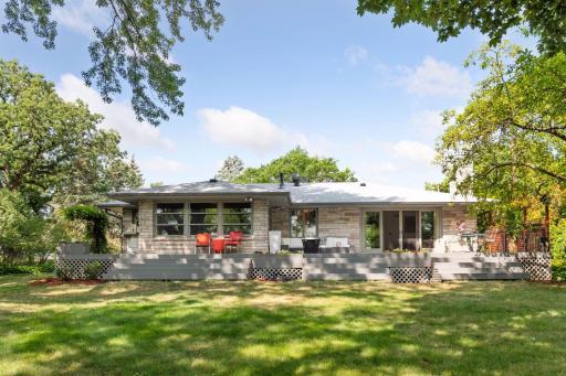 Expansive deck with a barbecue area create the ultimate entertainment space, while the large lawn offers endless possibilities for fun and relaxation.