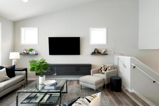 The vaulted ceiling in this gathering room makes it feel extra spacious! The custom built-in media cabinet and shelves are the perfect touch to the space! Sonos speakers in the ceiling of the gathering room are perfect for music and surround sound.
