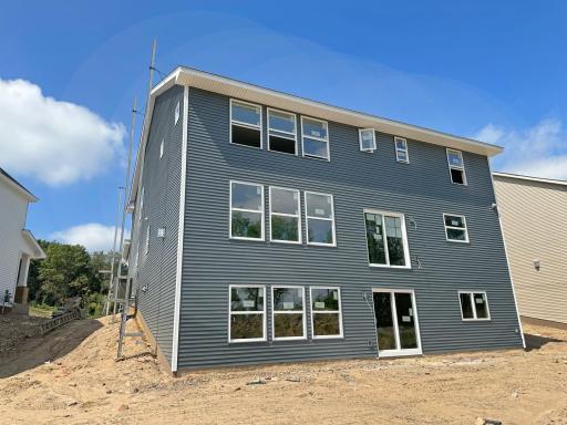 Walk Out lower level opens to a leveled yard for outdoor activities and enjoyment. The back drop view from this home also overlooks a natural setting of mature trees for privacy and natural beauty of the surroundings.