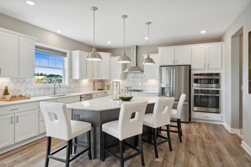 The kitchen is anchored with a generous island to seat up to FOUR guests.