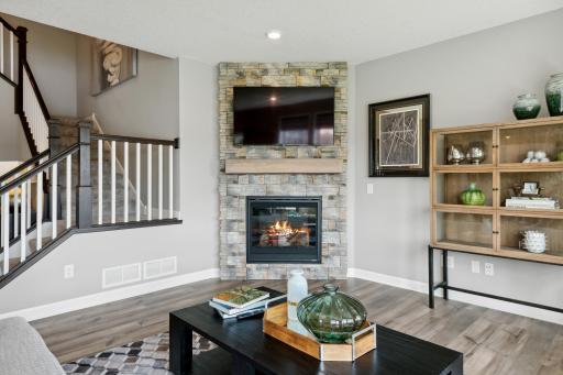 Full height natural stone fireplace adds a nice focal point to the living space.