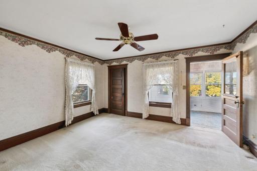 The main bedroom on the upper floor has the added bonus of being connected to the front 3-season porch.