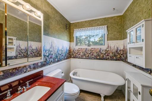 The full bath with a classic claw-foot tub is on the upper level with the bedrooms. A riser/extension could easily be installed to add a shower.